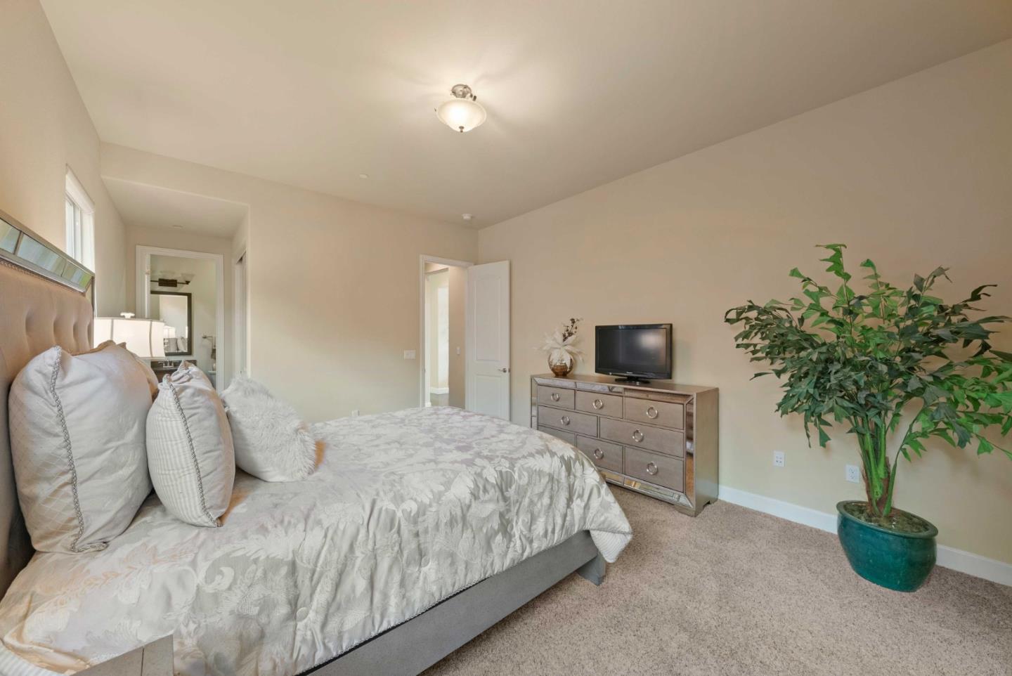 1477 Corte De Maria San Jose, CA 95120 - Photo 9 of 29 a bedroom with a bed and a potted plant