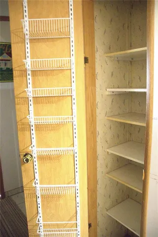 a view of a small space with wooden floor and a window