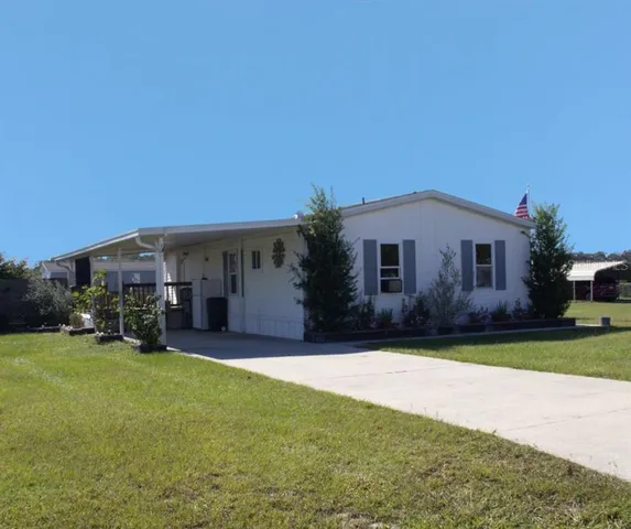 a view of a house with a yard and tree s