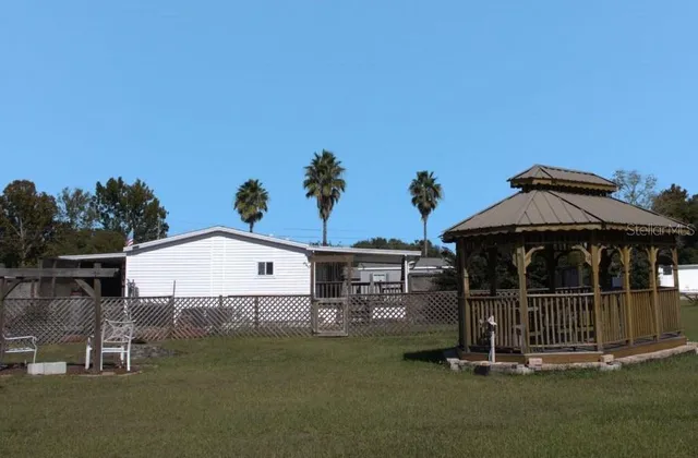 a view of a house with a yard and garage