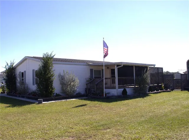 a view of a house with backyard and porch