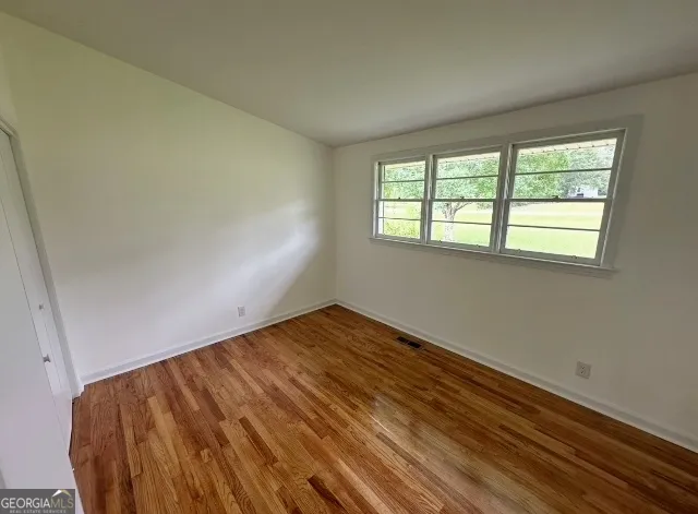 a bathroom with a sink and mirror with bathtub