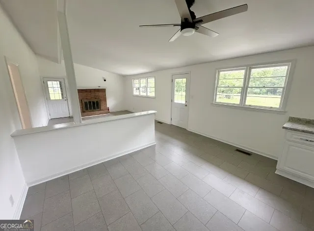 a kitchen with granite countertop a sink and a window