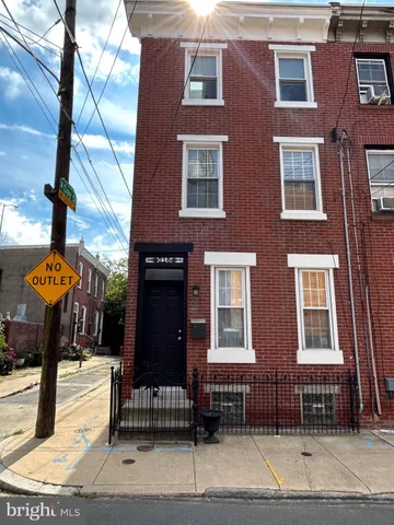 a front view of a brick building with many windows