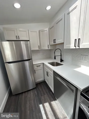 a view of a kitchen with a sink and washing machine