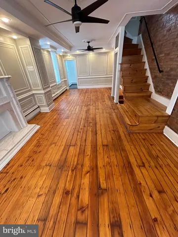 a view of a room with wooden floor