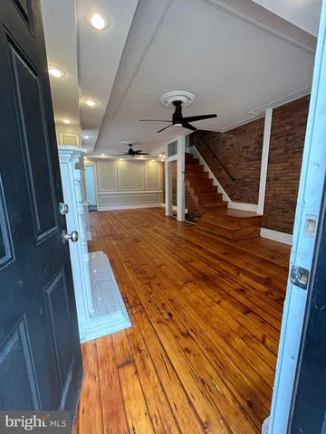 a view of livingroom with hardwood floor and a ceiling fan