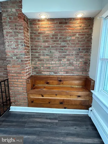 a room with a chair and cabinets