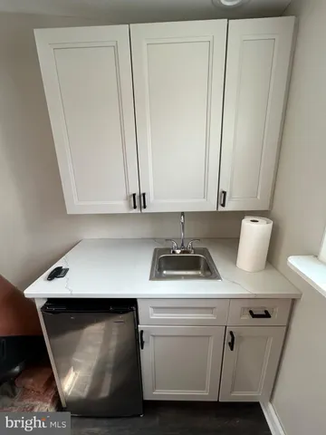 a room with a chair and a stove with wooden floor