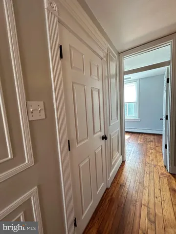 a view of room with window and wooden floor