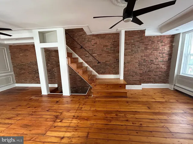 a view of a room with wooden floor