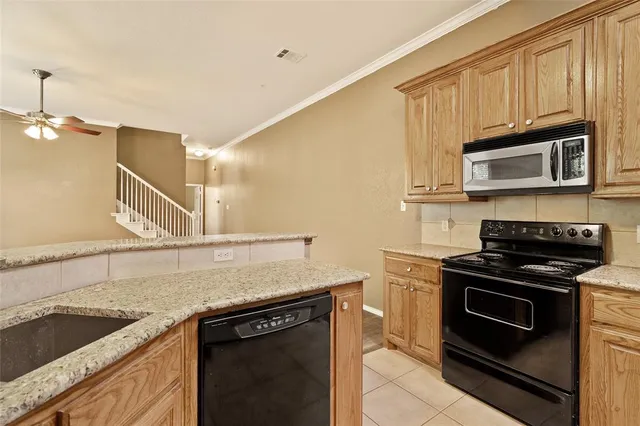 a kitchen with a sink a refrigerator and cabinets