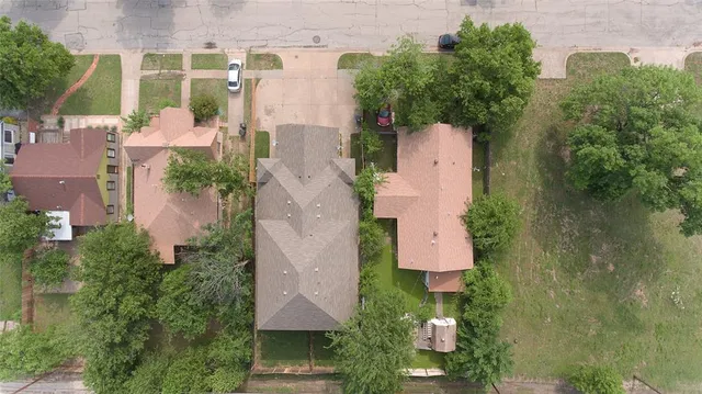 an aerial view of a house with a yard basket ball court and outdoor seating
