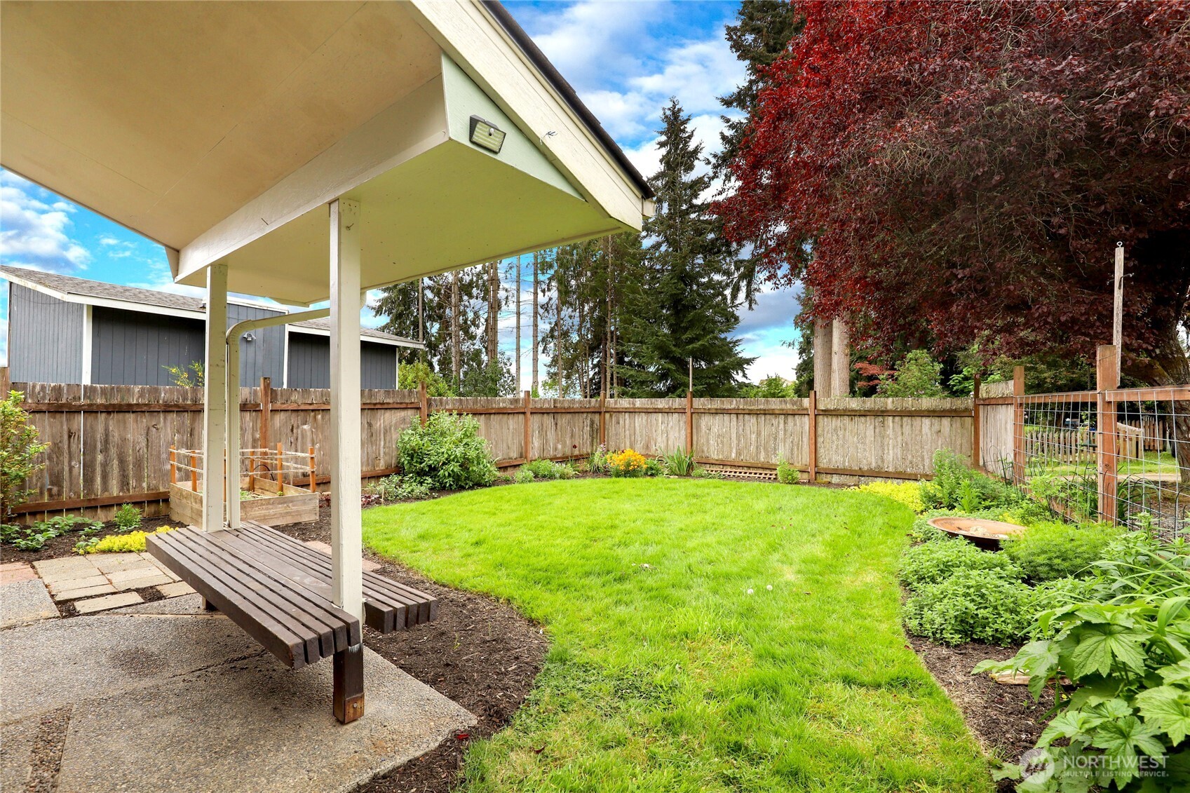 2417 Cedar Street East Port Orchard, WA 98366 - Photo 9 of 40 a backyard of a house with table and chairs
