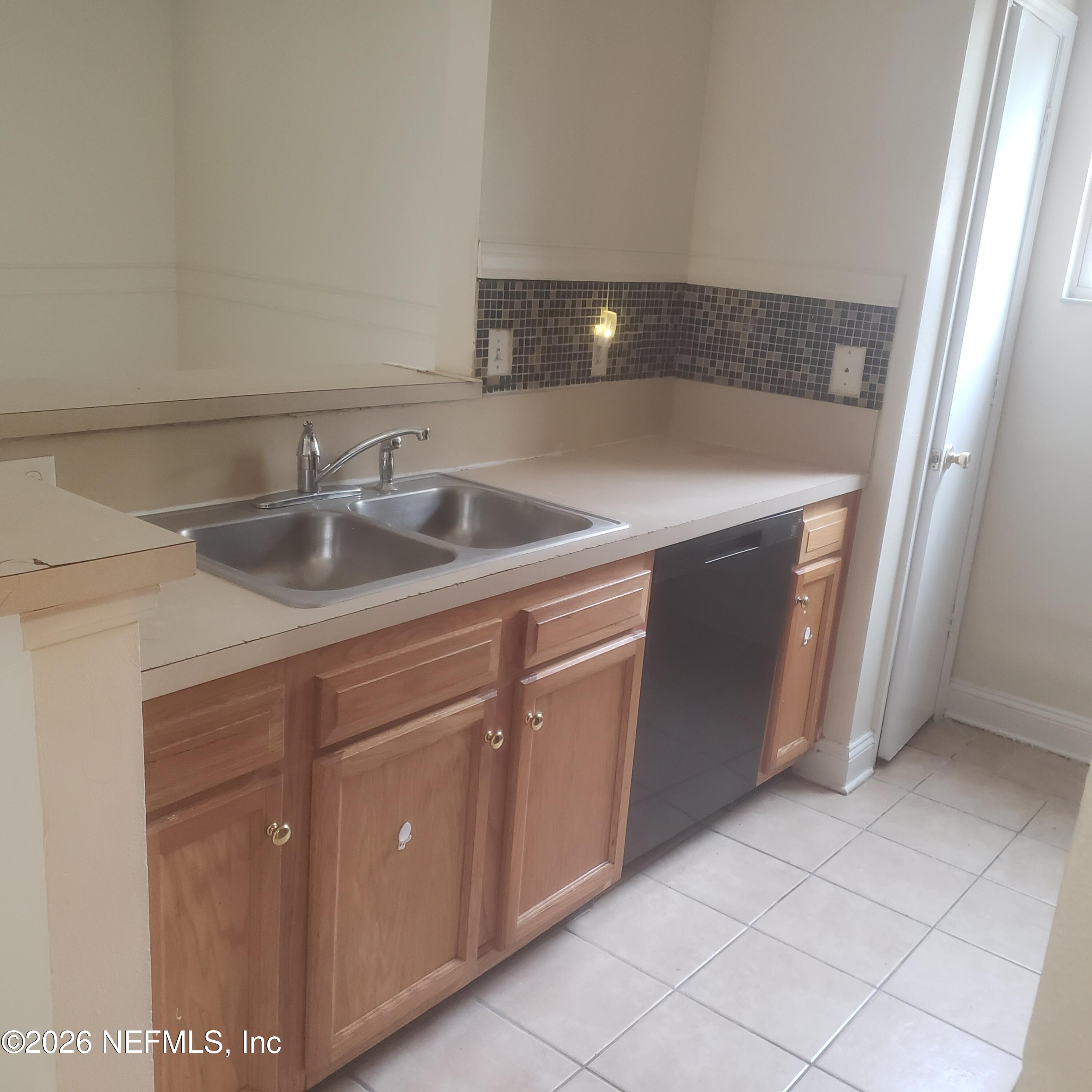 1530 West 29th Street Jacksonville, FL 32209 - Photo 4 of 12 a kitchen with a sink and cabinets