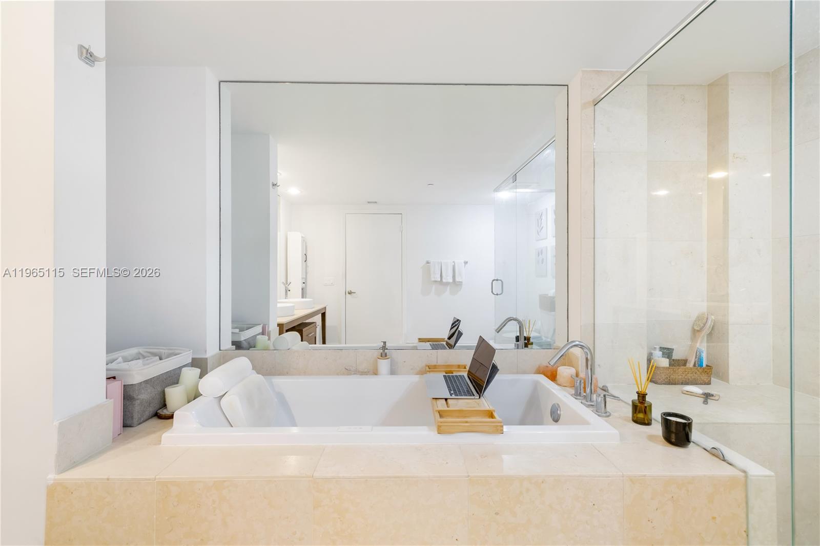 495 Brickell Avenue, Unit 4704 Miami, FL 33131 - Photo 15 of 24 a bathroom with a tub a sink and a large mirror