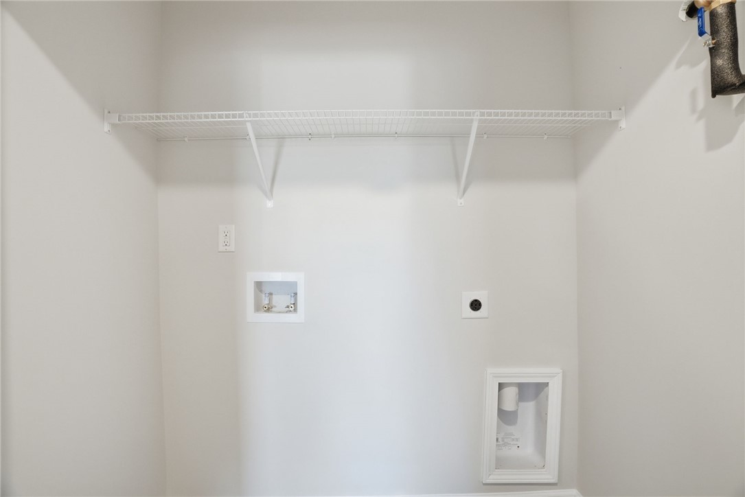 305 Lilac Loop Greenwood, SC 29646 - Photo 16 of 25 Ready for your appliances, this utility room includes essential hookups and a convenient storage shelf.
