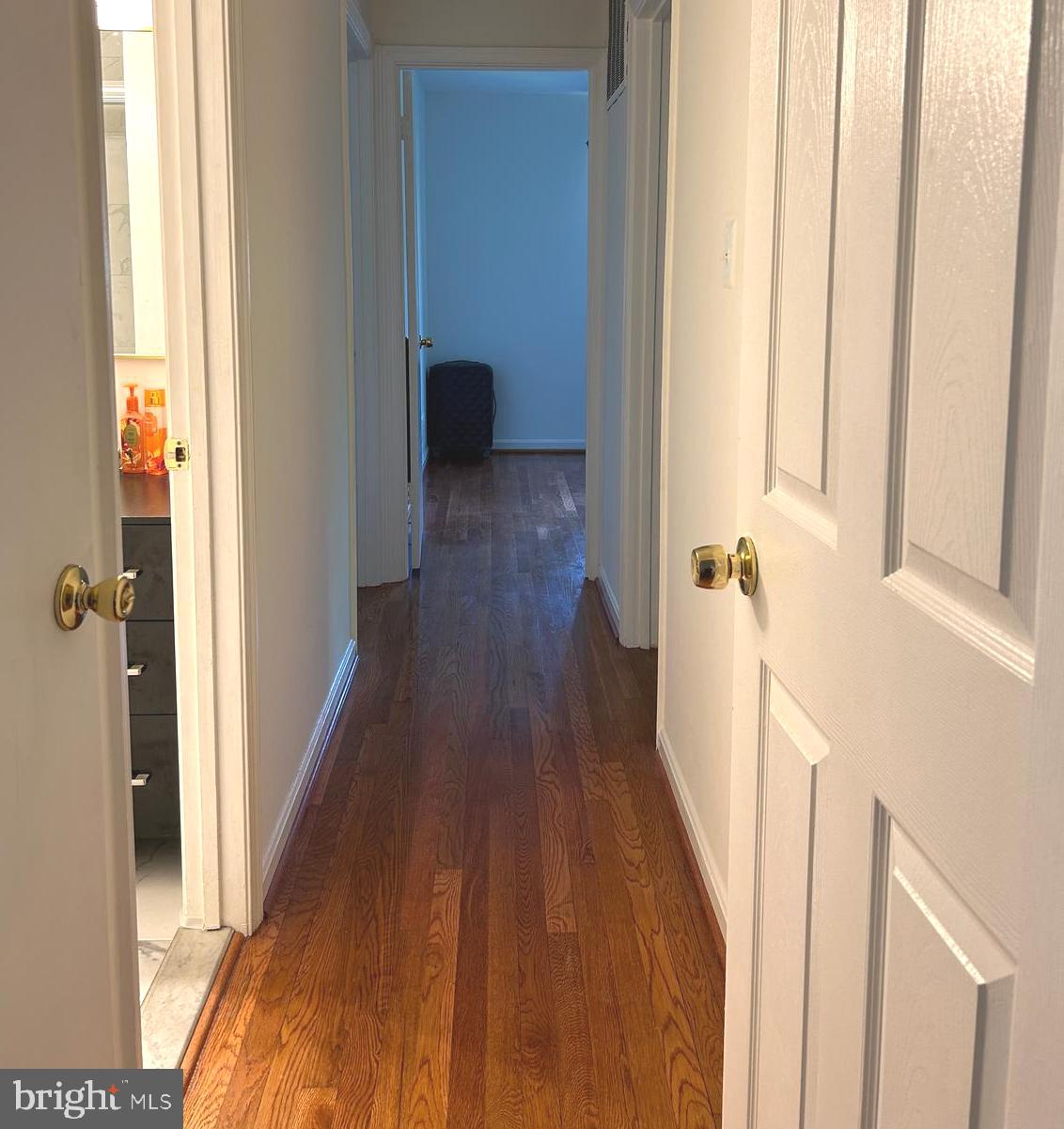 5606 Ventnor Lane Springfield, VA 22151 - Photo 16 of 24 a view of a hallway with wooden floor and staircase