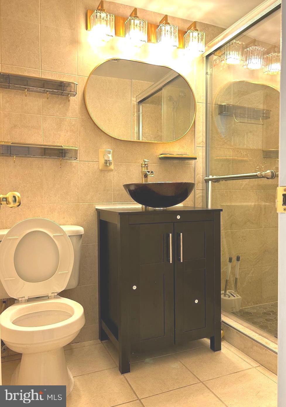 5606 Ventnor Lane Springfield, VA 22151 - Photo 21 of 24 a bathroom with a toilet sink and mirror