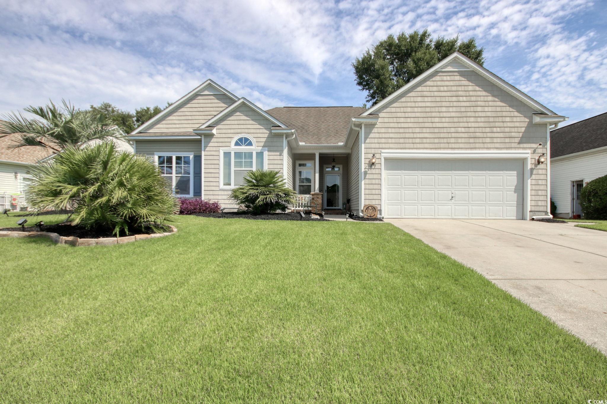 47 Pinfeather Drive Murrells Inlet, SC 29576 - Photo 1 of 35 View of front of home with an attached garage, concrete driveway, and a front yard