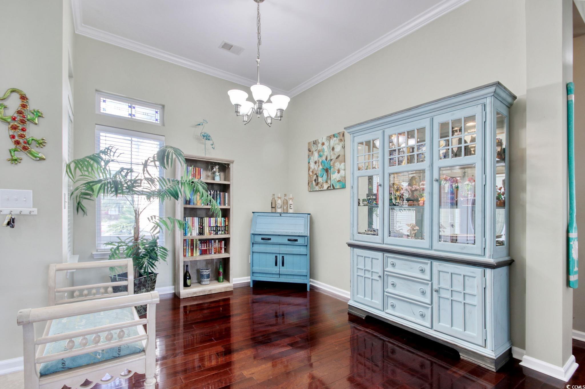 47 Pinfeather Drive Murrells Inlet, SC 29576 - Photo 6 of 35 Dining area with ornamental molding, dark wood-type flooring, and a chandelier
