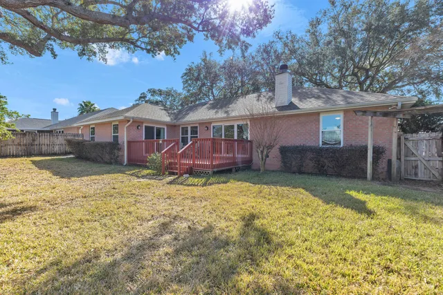 a view of a house with a yard and roof