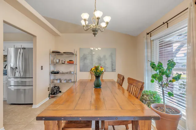 a dining room with furniture and a chandelier