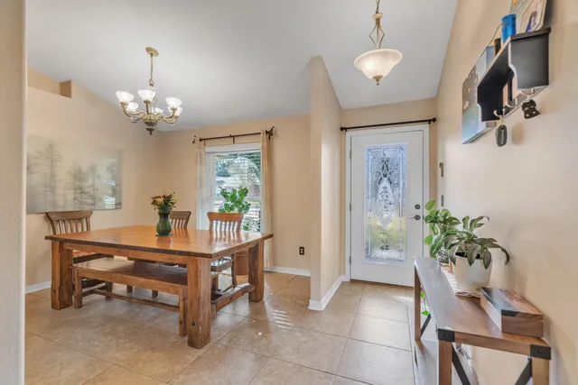 a view of a dining room with furniture and a chandelier