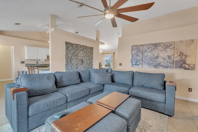 a living room with furniture and a chandelier