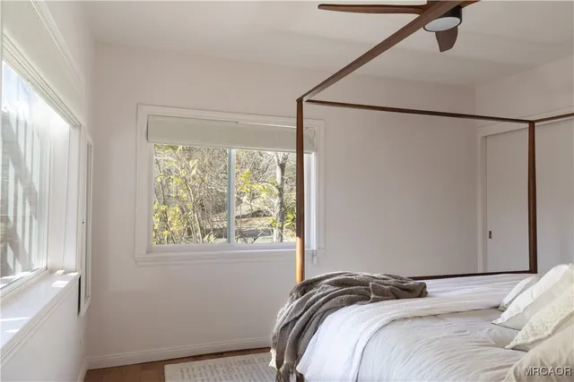 a view of a bedroom with a bed and a window