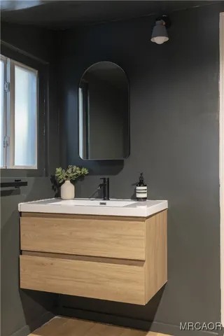 a bathroom with a sink and a mirror