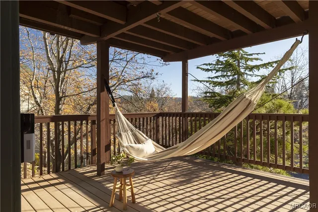 a view of balcony with wooden floor and fence