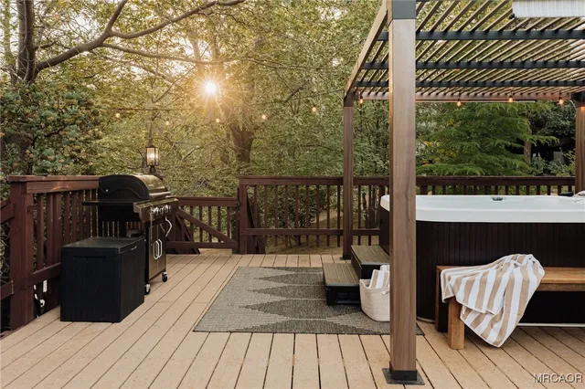 a balcony with wooden floor table and chairs