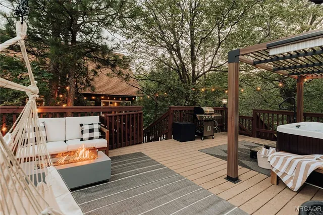 a view of a patio with couches chairs and wooden floor