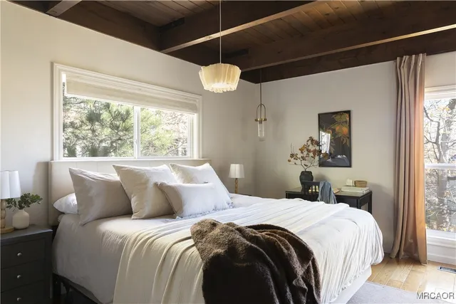 a bedroom with a bed and a window