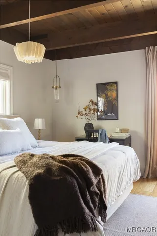 a bedroom with a bed and a chandelier