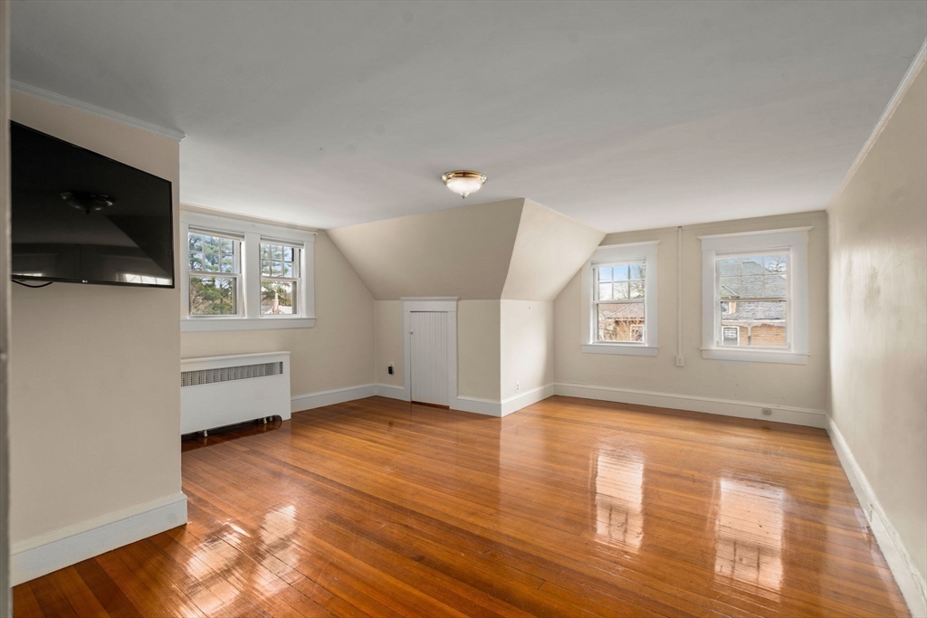 12 Leighton Road Wellesley, MA 02482 - Photo 23 of 34 an empty room with wooden floor and windows