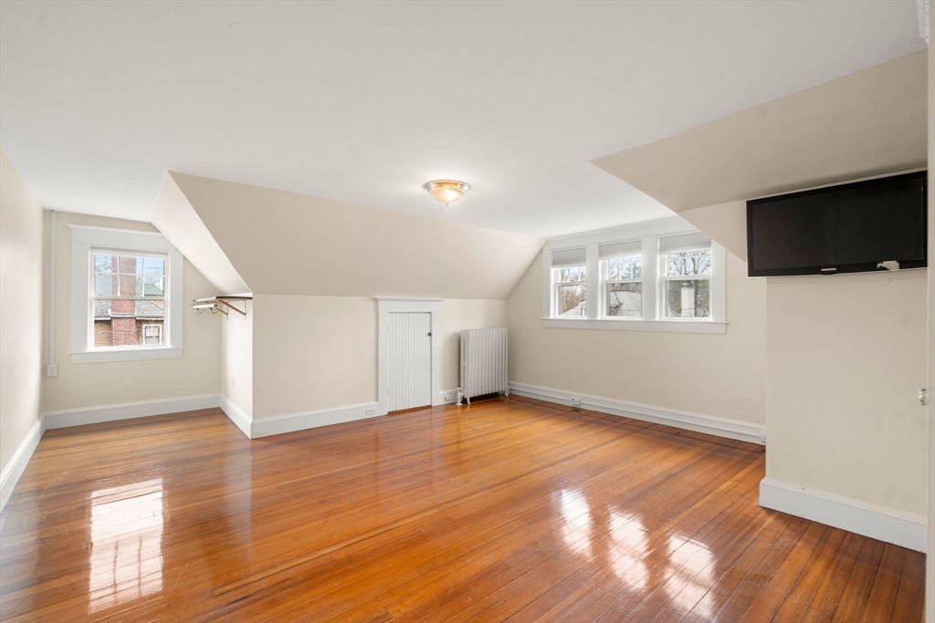 12 Leighton Road Wellesley, MA 02482 - Photo 24 of 34 a view of an empty room with wooden floor and a window