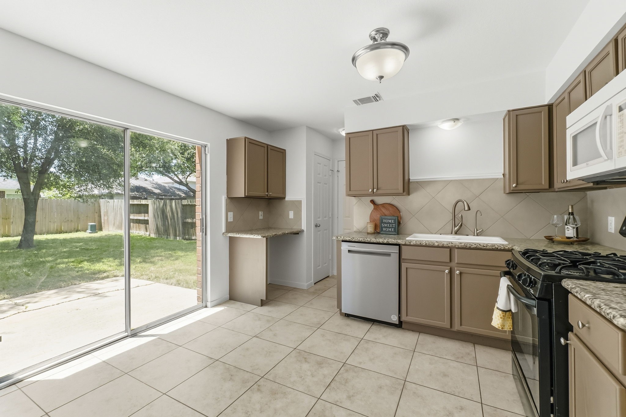 11907 Ezekiel Road Tomball, TX 77375 - Photo 12 of 39 a kitchen with a stove sink and cabinets