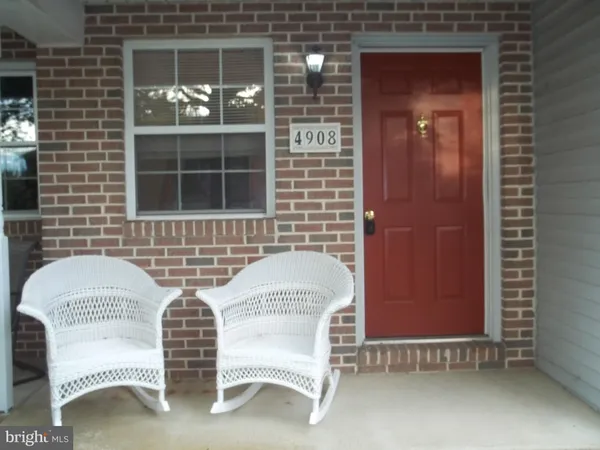 a couple of chairs sitting in front of a door