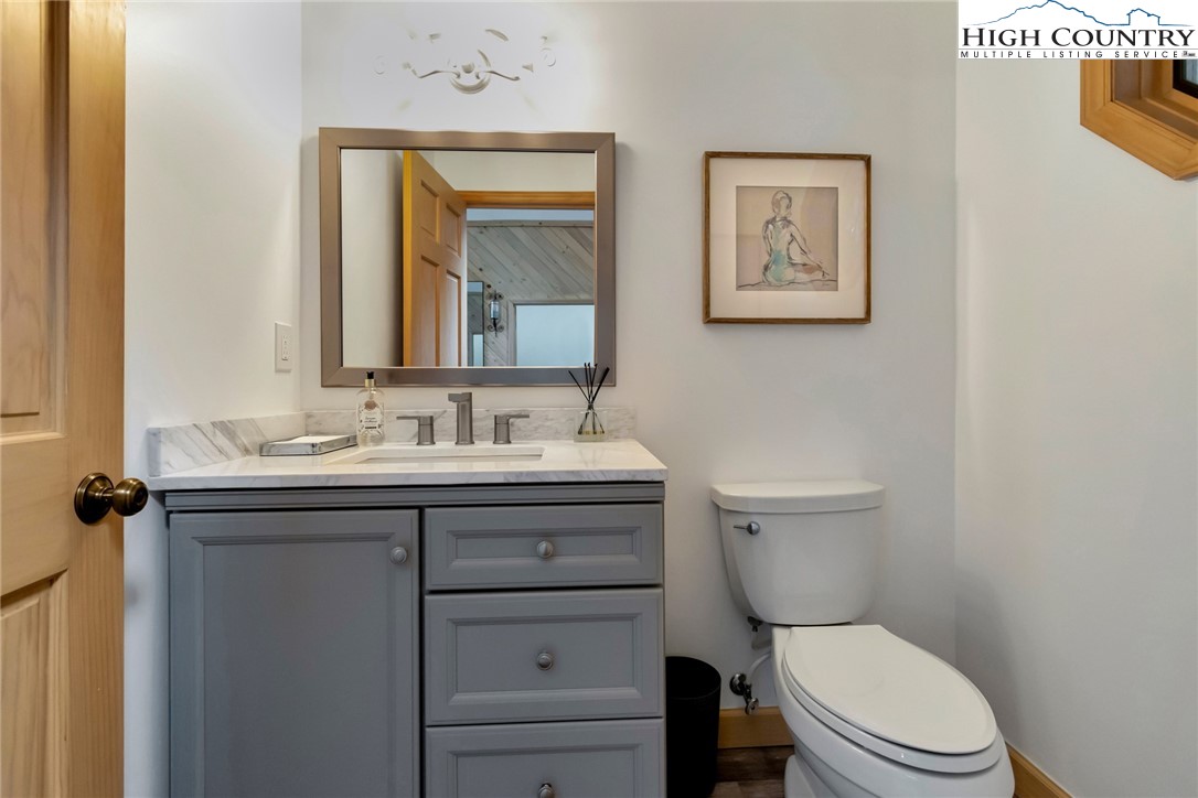 202 Pinnacle Ridge Road Beech Mountain, NC 28604 - Photo 5 of 48 a bathroom with a toilet a sink and mirror