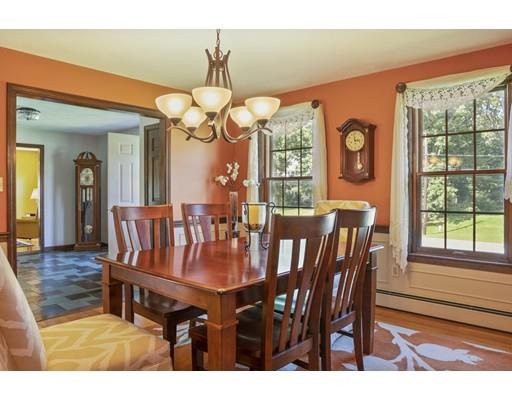 21 Crestview Drive Millis, MA 02054 - Photo 10 of 31 a dining room with wooden floor a chandelier a wooden table and chairs