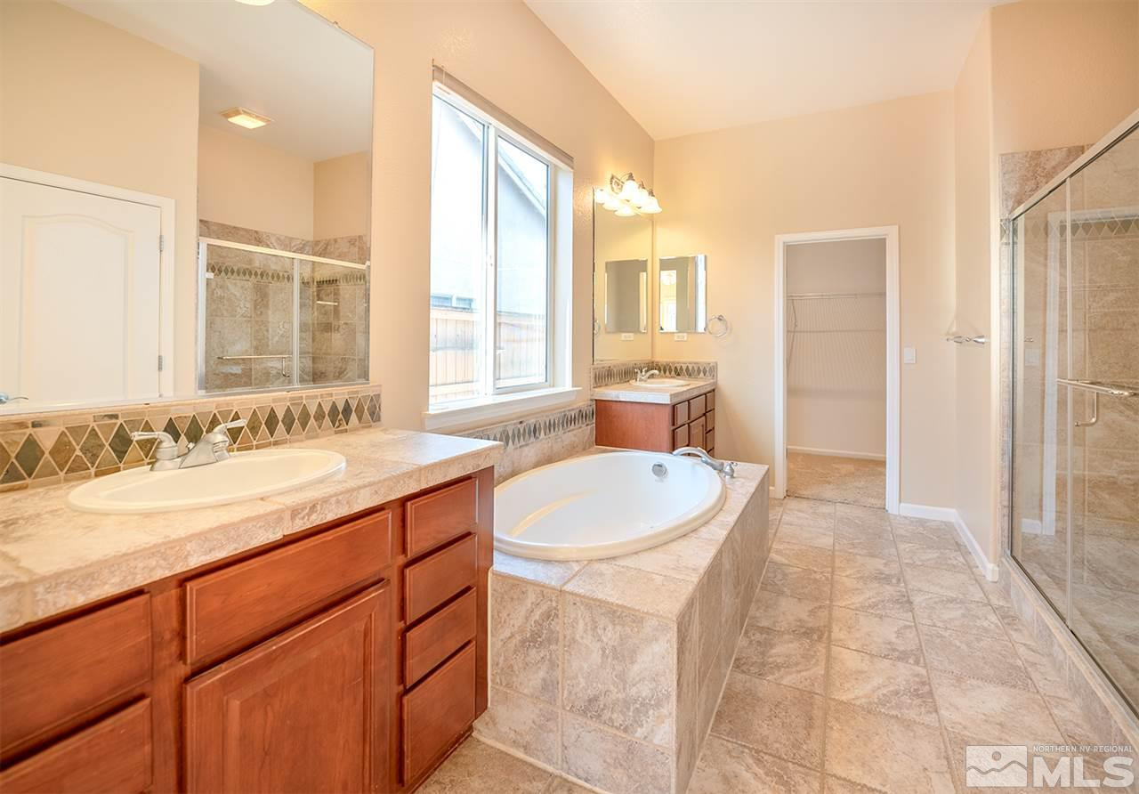 10645 Summer Glen Drive Reno, NV 89521 - Photo 21 of 25 a spacious bathroom with a granite countertop sink and a bathtub