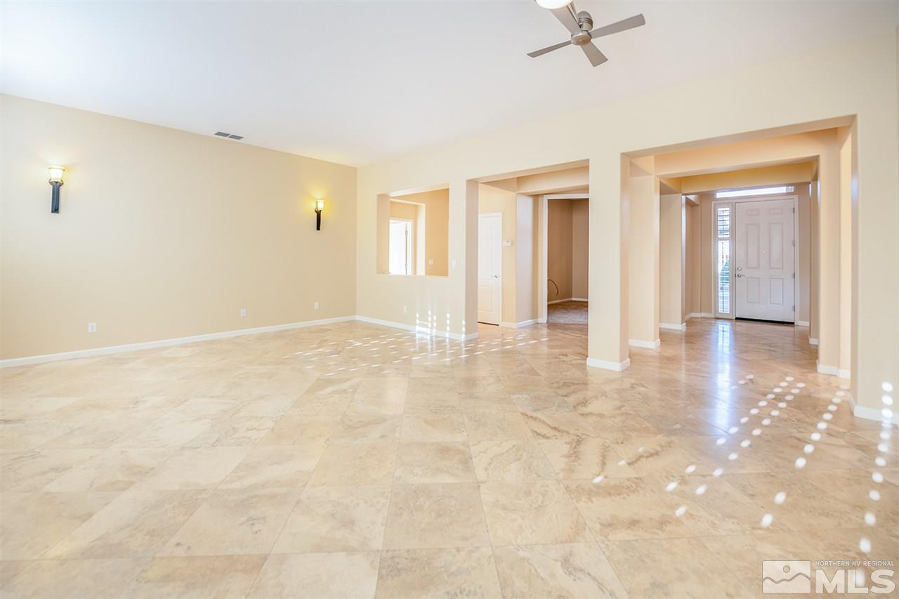 10645 Summer Glen Drive Reno, NV 89521 - Photo 6 of 25 an empty room with kitchen view and windows