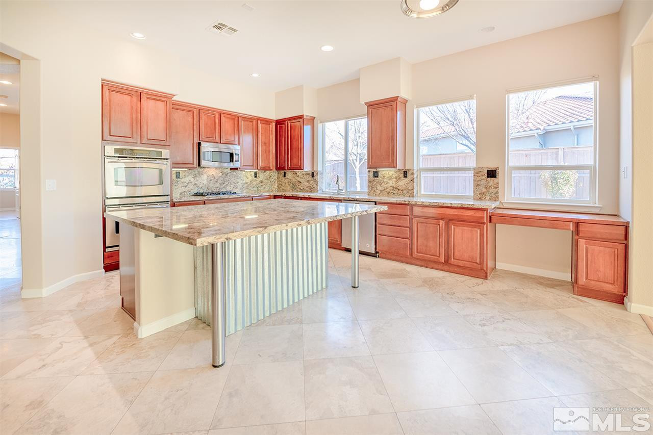 10645 Summer Glen Drive Reno, NV 89521 - Photo 10 of 25 a kitchen with stainless steel appliances granite countertop a stove a sink and a refrigerator