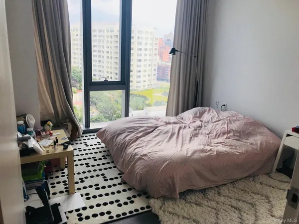 a bed sitting in a bedroom next to a window