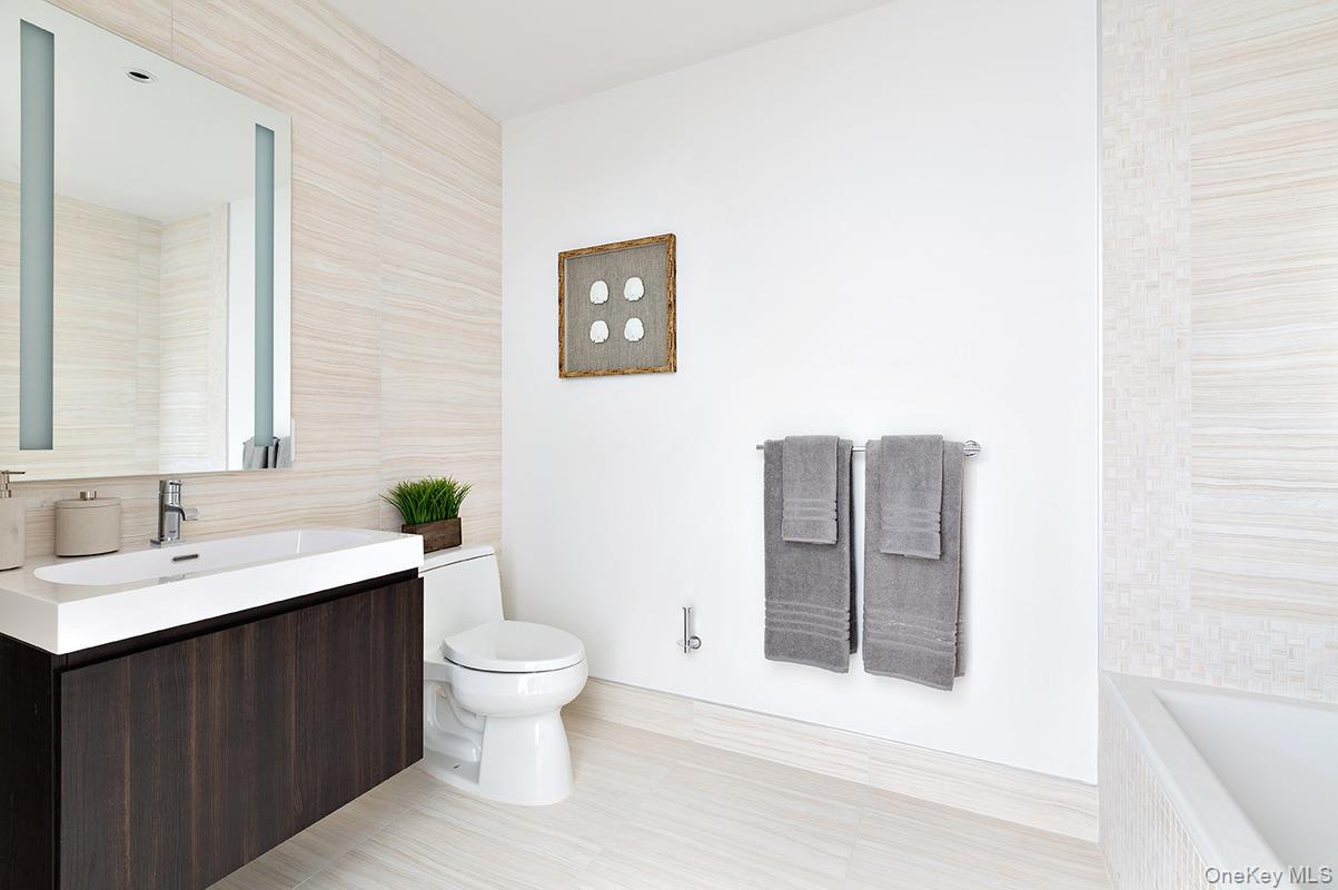 131-01 40 Road, Unit 19A Queens, NY 11354 - Photo 4 of 21 a bathroom with a sink and a toilet