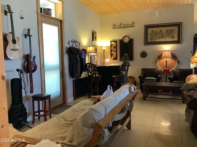 a living room with furniture rug and lamp