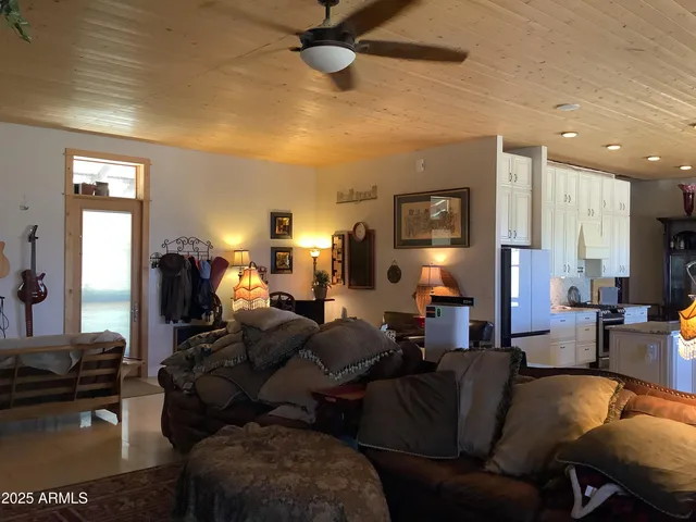 a living room with furniture and a lamp