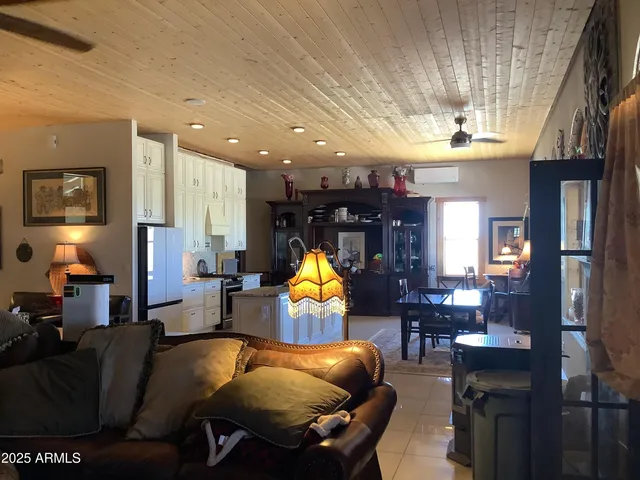 a living room with furniture a chandelier and a fireplace
